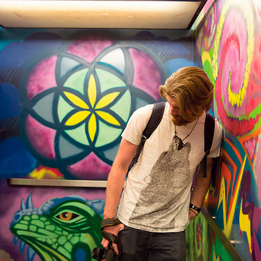 Student leaning against colorful elevator wall